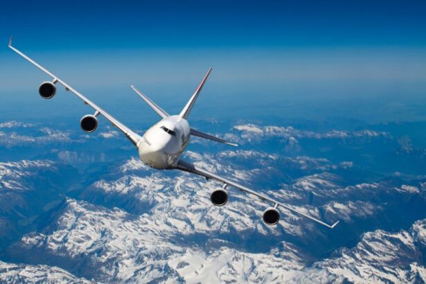 Un avion zburând deasupra munților acoperiți de zăpadă, într-un cer senin.